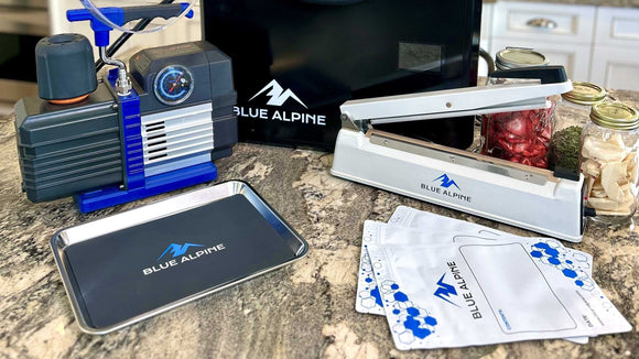Accessories and supplies for the blue alpine freeze dryer. Picture includes vacuum pump, tray, silicone tray, mylar bags, vacuum sealer, and a black freeze dryer