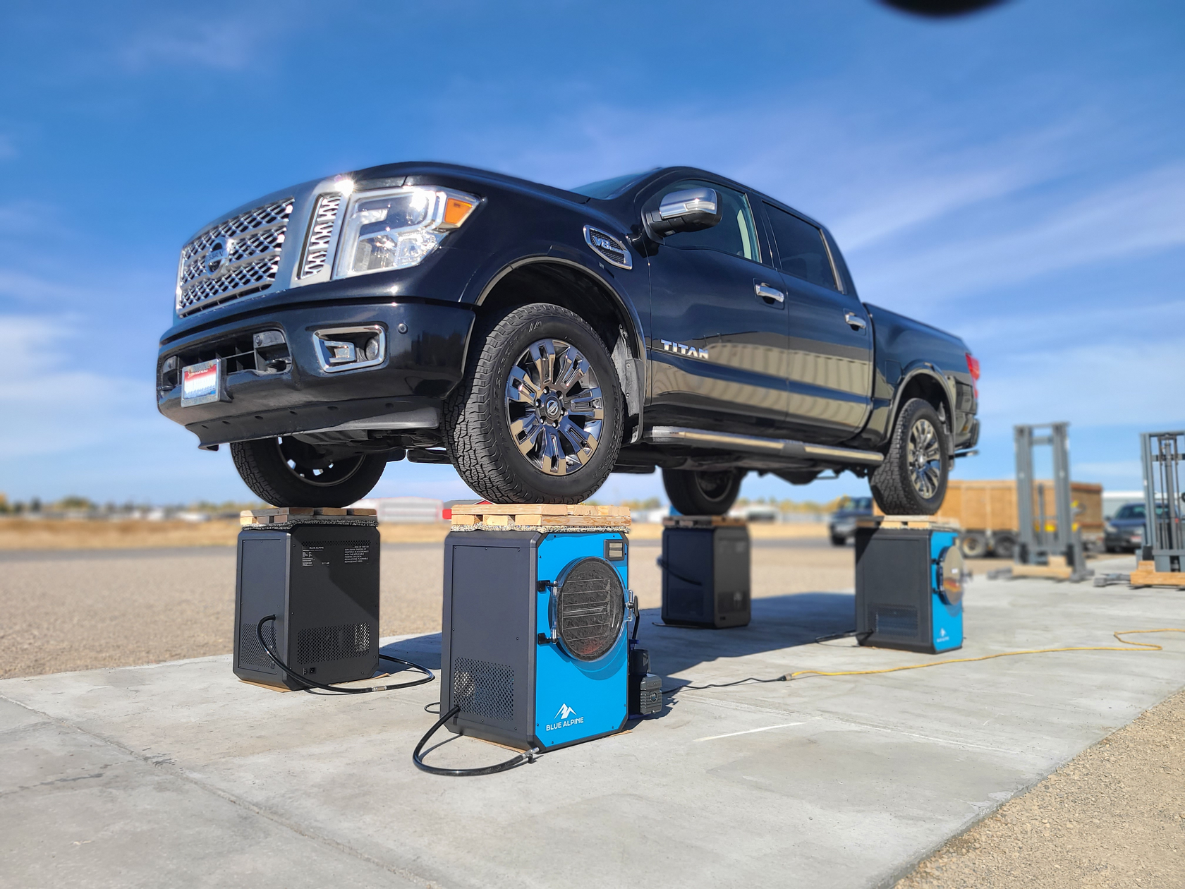 Black Titan Truck Standing ON 4 Blue Alpine Freeze Dryers